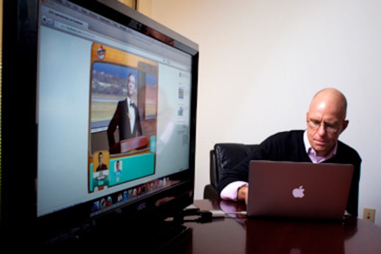 Gene Mauro, president and chief operating officer of Entertainment Games, a video-game company in Langhorne that is about to launch its latest product, Retro World, checks a presentation of the new game. (Ed Hille / Staff Photographer)