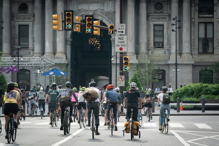 Participants in a group bicycle ride led by the Bicycle Coalition of Greater Philadelphia arrive at City Hall on May 20, 2022.