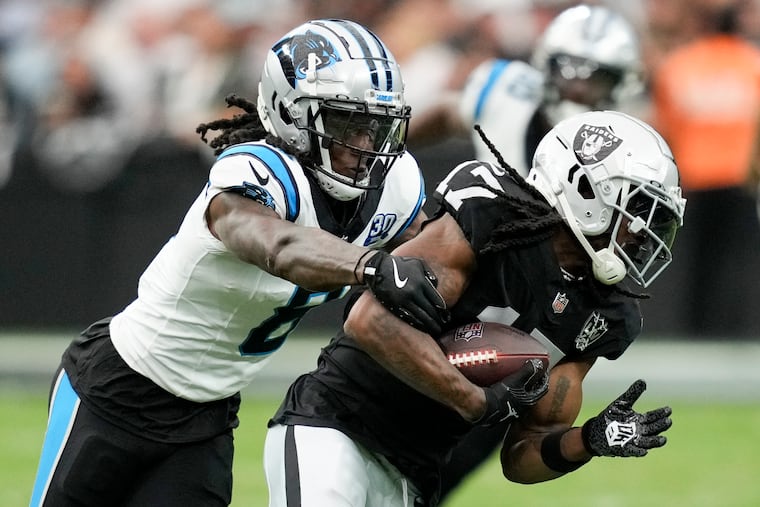 Las Vegas Raiders wide receiver Davante Adams is tackled by Carolina Panthers cornerback Jaycee Horn on Sept. 22.