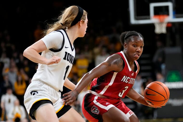North Carolina State guard Diamond Johnson (3) drives past Iowa guard Molly Davis during a game in December. Johnson starred at Neumann Goretti before playing at Rutgers and NC State.