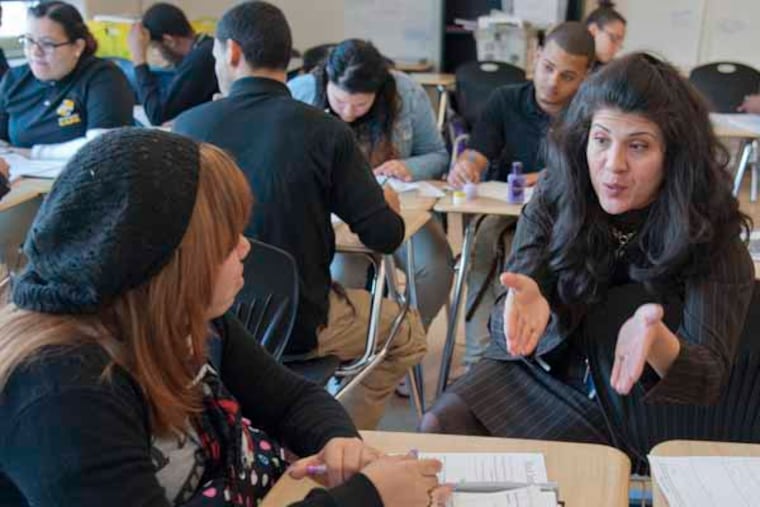 Debora Carrera (cq), the principal of Kensington Creative and Performing Arts High School, talks with a senior in social science class. With the drastic budget cuts in the Philadelphia School District, principals and teachers are forced to do more, and different things, to support their students. ( CLEM MURRAY / Staff Photographer )