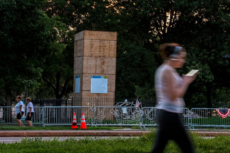 The statue of Christopher Columbus remains encased in a wooden box on Marconi Plaza Aug. 12, 2020.