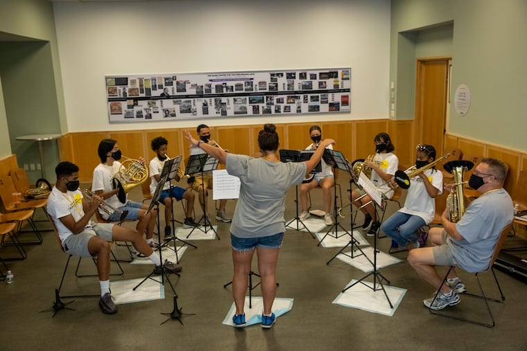 Teacher Sabrina Huber conducts the brass chamber ensemble during the All-City Orchestra Summer Academy at the Mann Center for the Performing Arts.