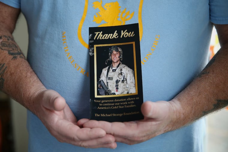 Charles Strange shows a picture of his son at his home in Hatboro, Pa.,in 2019.