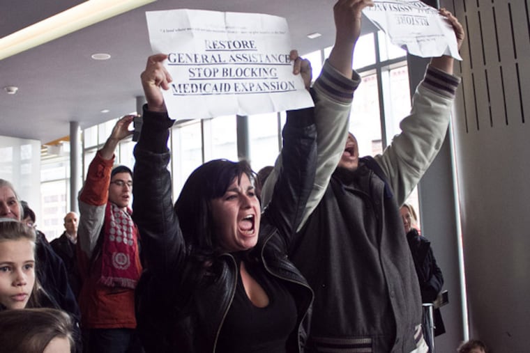Members of the AIDS Coalition to Unleash Power (ACT UP) protest Gov. Corbett's decision to block Medicaid expansion in Pennsylvania under the Affordable Healthcare Act. (Kaytee Riek, flickr)