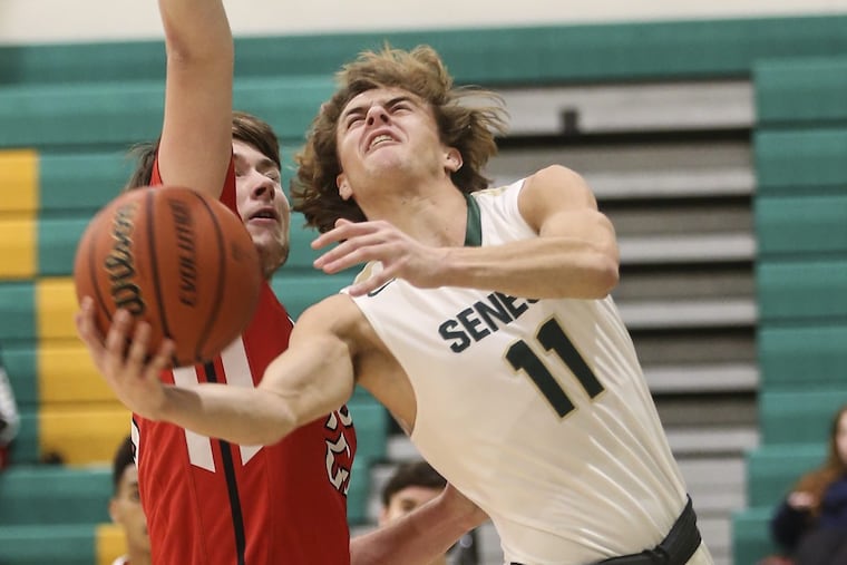 Seneca’s Jack Brockett shooting as Cherry Hill East’s Colin Prendergast defends on Tuesday night.