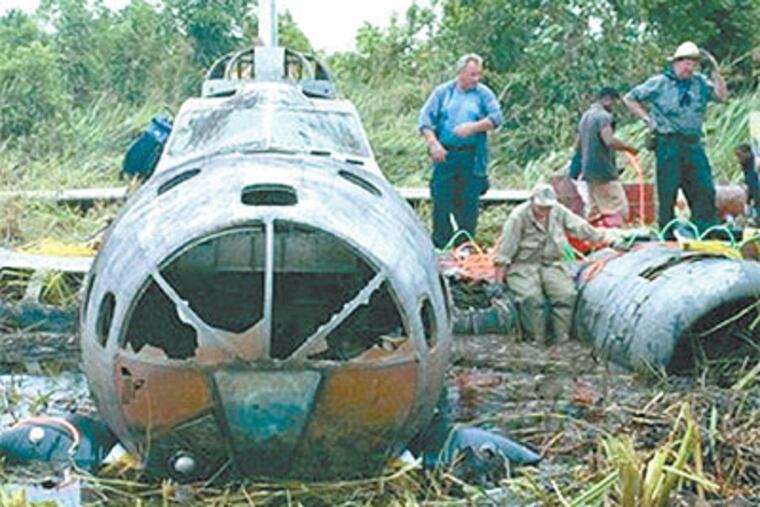 A salvage team prepares to remove a B-17 bomber from a Papua New Guinea swamp, where it has rested since 1942. (Michael Murray / Adrenaline Films)