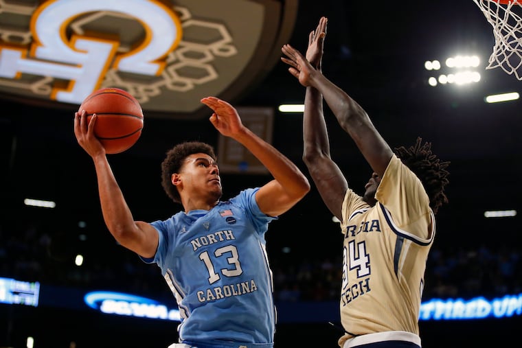 North Carolina guard Cameron Johnson (13) shoots as Georgia Tech forward Abdoulaye Gueye (34) defends during the second half of an NCAA college basketball game in Atlanta, Tuesday, Jan. 29, 2019. (AP Photo/Todd Kirkland)