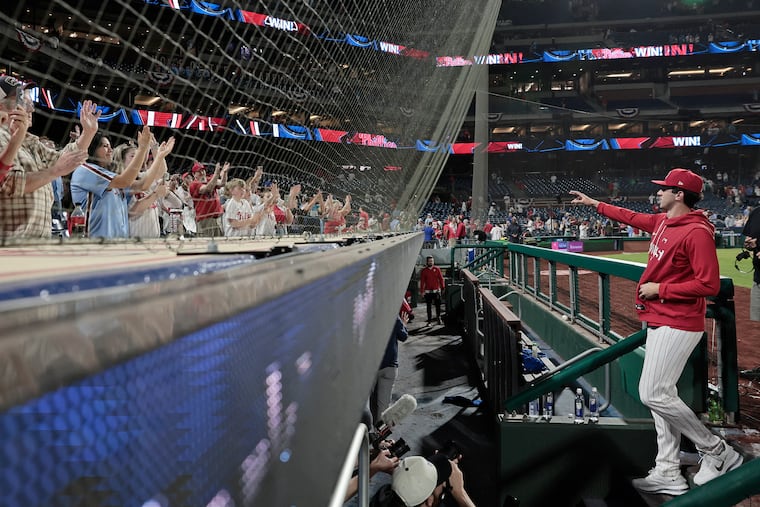 Phillies pitcher Andrew Painter waves to cheering fans as he goes into the clubhouse after he made his major league debut on Tuesday.
