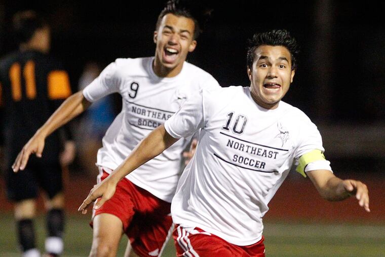 Northeast's Adin Hernandez runs towards the student section after kicking the game-winning goal in overtime against Furness.
