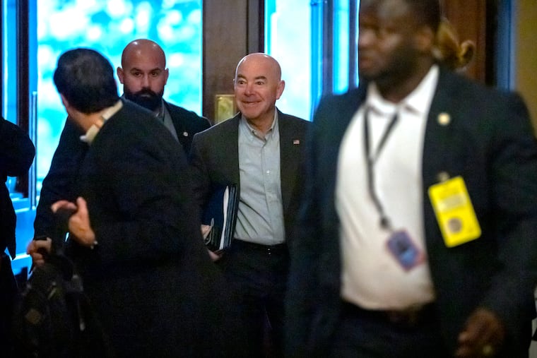 Homeland Security Secretary Alejandro Mayorkas, center, arrives for closed-door negotiations on a border security deal at the Capitol on Sunday in Washington.