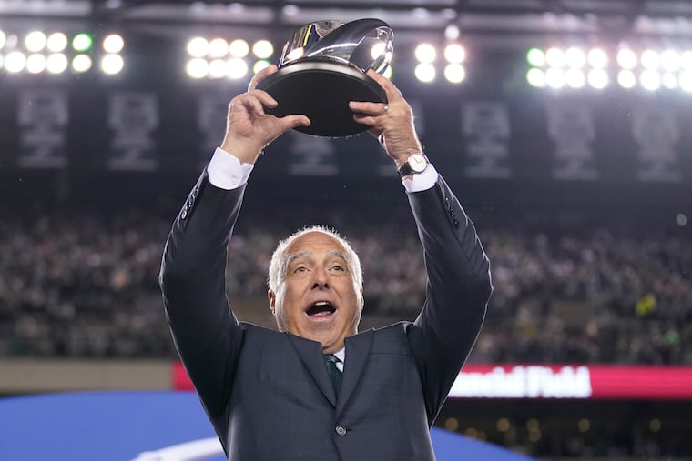 Eagles owner Jeffrey Lurie hoists the George Halas Trophy. He says that way back in September, he believed it should be his.