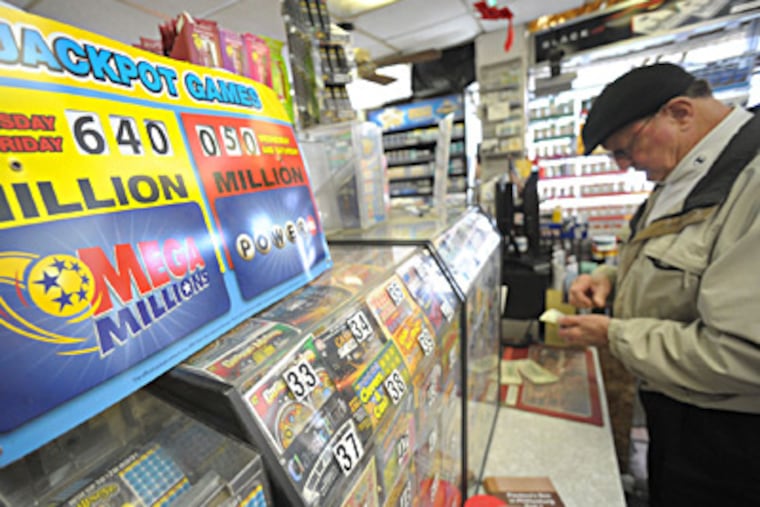 A player checks his Mega Millions ticket at Towne Market in Phillipsburg, N.J. The jackpot for Friday's drawing was up to $640 million Friday afternoon, or $462 million for the cash up front. MATT SMITH / The Express-Times