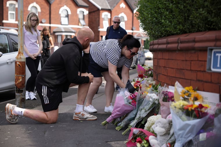 People leave flowers near the scene of a deadly knife attack during a Taylor Swift event at a dance school on Monday in Southport, England.