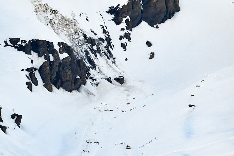 Rescue crew work on the avalanche site, at the ski resort of Crans-Montana, Switzerland, Tuesday, Feb. 19, 2019. Swiss response teams rescued at least a few people among those swept up and buried in a mid-afternoon avalanche Tuesday at the popular ski resort of Crans-Montana, police said. A frenzied search involving helicopters and rescuers “saved several people,” said spokesman Steve Leger of the Valais police, but the state of their injuries was not immediately known.