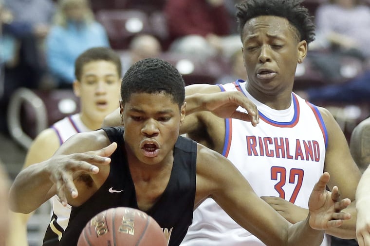 TaQuan Woodley, left, battles for a rebound in Neumann-Goretti's 57-72 romp over Richland in last year's PIAA Class 3A state final in Hershey.
