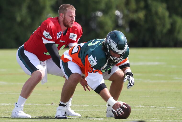 Eagles quarterback Carson Wentz and center Jason Kelce practice a snap during practice at the NovaCare Complex in South Philadelphia on Friday.