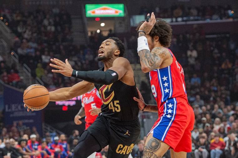 The Cleveland Cavaliers' Donovan Mitchell drives to the basket as Kelly Oubre Jr. defends him on Saturday.