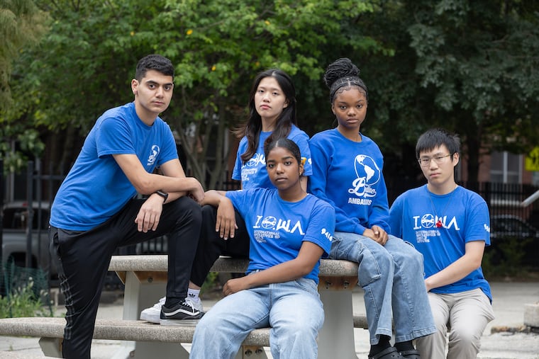Members of the Bodine robotics and debate teams including Khader Motan (far left, standing) and Julianna Tejada (center front, wearing blue jeans) had spoken out about funding cuts to Philadelphia School District extracurricular activities like theirs.