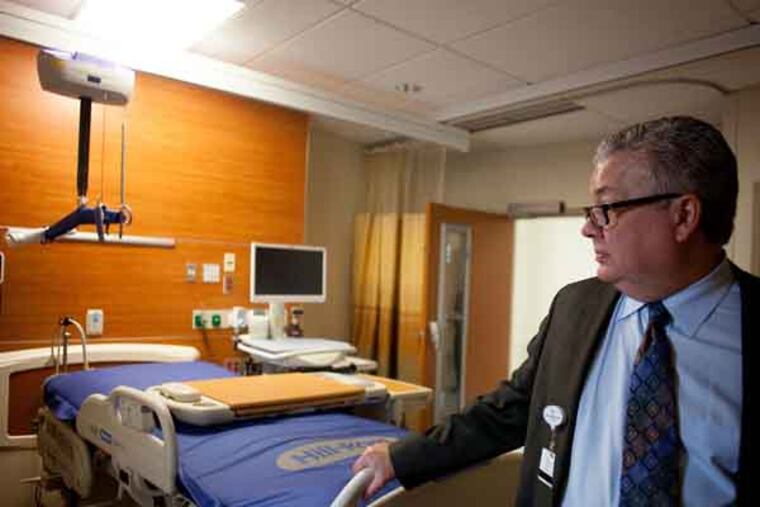 Phillip Robinson, president of Lankenau Medical Center, shows one of the new rooms in the center's new $465 million Heart Pavilion on July 23, 2013 in Wynnewood. ( ANDREW RENNEISEN / Staff Photographer )
