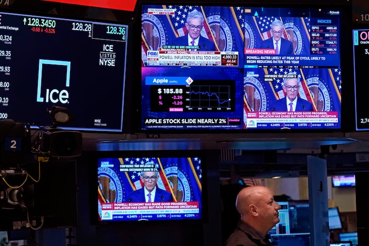 Federal Reserve Chair Jerome Powell's speech on Jan. 31 is projected on television screens on the floor of the New York Stock Exchange.