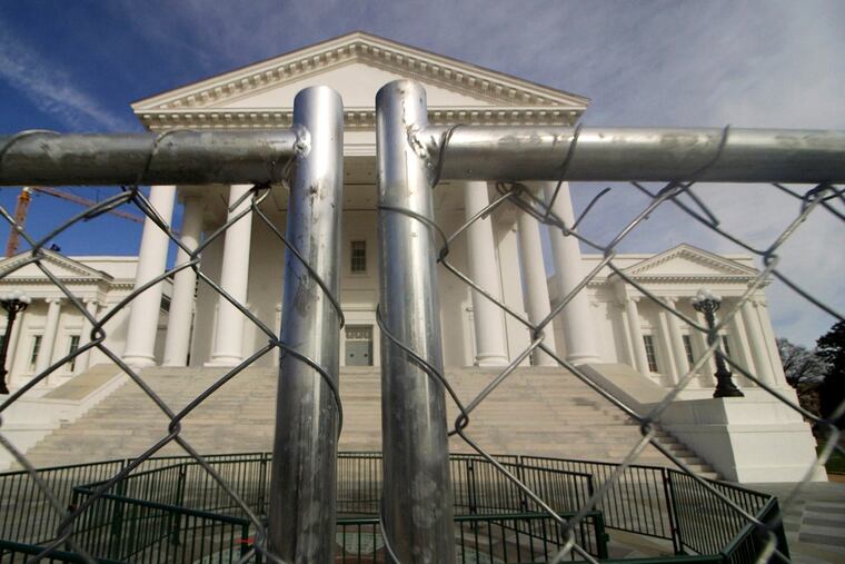 The Virginia Capitol building in Richmond is surrounded by fencing on Thursday in preparation for Monday's rally by gun-rights advocates.