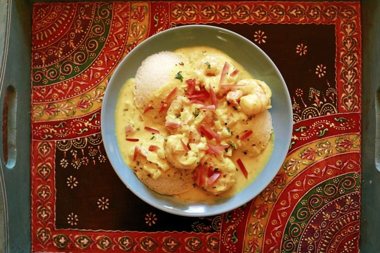 Chaat & Chai's poached shrimp in turmeric-tinted coconut sauce over idli rice-and-lentil cakes.