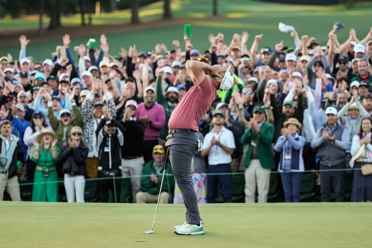 Jon Rahm celebrates on the 18th green after winning the Masters by four shots at 12-under par.