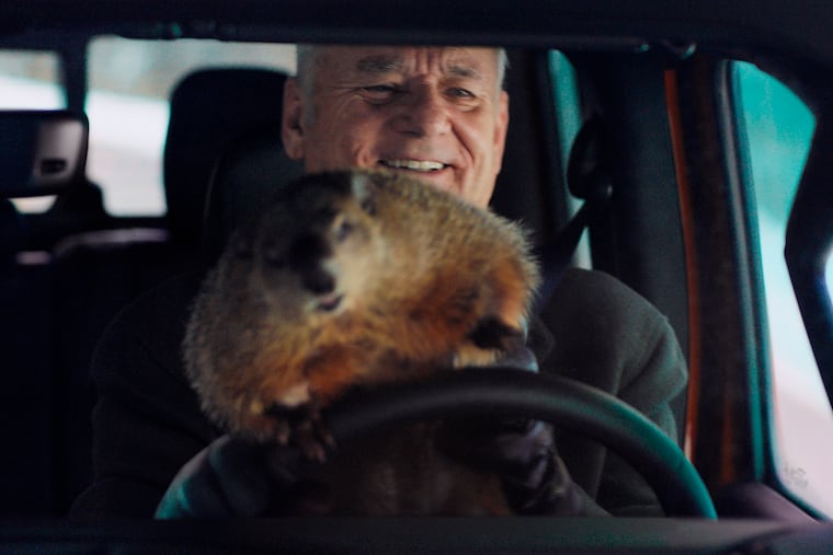 This undated image provided by Jeep shows Bill Murray reprises his role as Phil Connors from the 1993 film “Groundhog Day,” in a scene from the company's 2020 Super Bowl NFL football spot. The groundhog is "Poppy," a rescued groundhog from Lancaster.