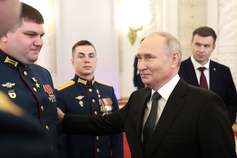 Russian President Vladimir Putin talks with awarded Russian servicemen after a ceremony to present Gold Star medals to Heroes of Russia on the eve of Heroes of the Fatherland Day at the St. George Hall of the Grand Kremlin Palace in Moscow, Russia, on Friday, Dec. 8, 2023.