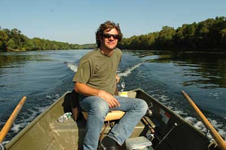 Mickey Melchiondo, one half of Ween, guides his 12-foot johnboat along the Delaware River. (CLEM MURRAY / Staff Photographer)