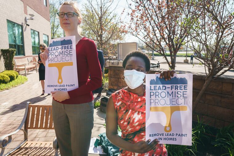 Colleen McCauley, left, Co-Chair, Lead-Free Promise Project, and Health Policy Director at Children First and Harriet Okatch, right, Assistant Professor of Public Health at Thomas Jefferson University and Co-Chair of the Lead-Free Promise Project hold signs at a news conference to announce more than $25 million in funding for maternal and child health, at Temple University Hospital for Women’s Health, in Philadelphia on Thursday.