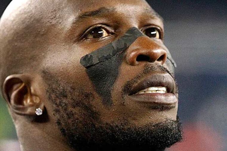 What does a former NFL wide receiver do with his time? If you're Chad "Ochocinco" Johnson, you spend the day hanging out with a homeless guy. (Elise Amendola/AP file photo)