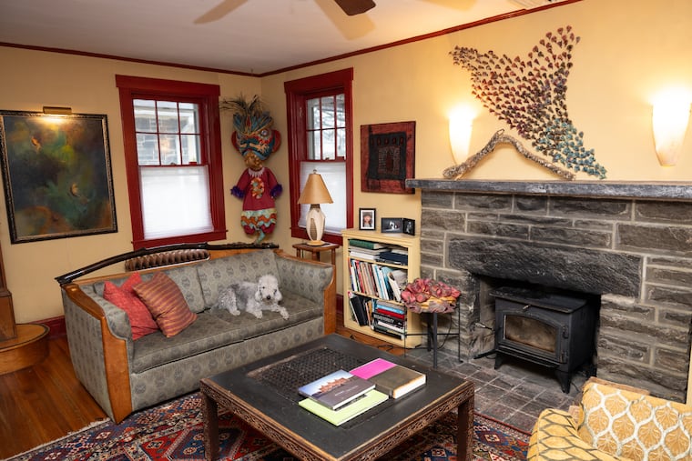 A Narberth psychotherapist has added many artistic touches to her home, including in the living room, where three-dimensional artwork hangs above the mantel, and a costume she made for her daughter is displayed in a corner.