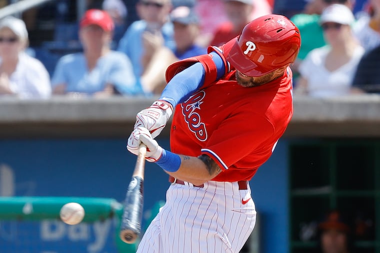 The Phillies' Jake Cave hits a single in the second inning of a 7-6 victory over the Orioles on Thursday.