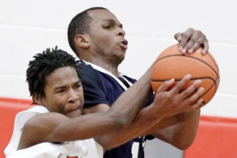 Lenape's Avery Brown and Atlantic City's Kayshawn Dunston battle for a rebound. (Elizabeth Robertson / Staff Photographer)