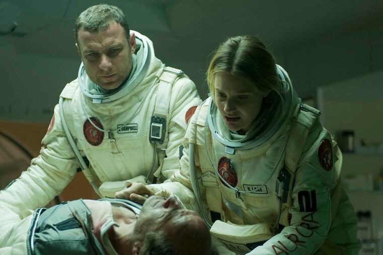 Liev Schreiber and Romola Garai check on Elias Koteas in "The Last Days on Mars."