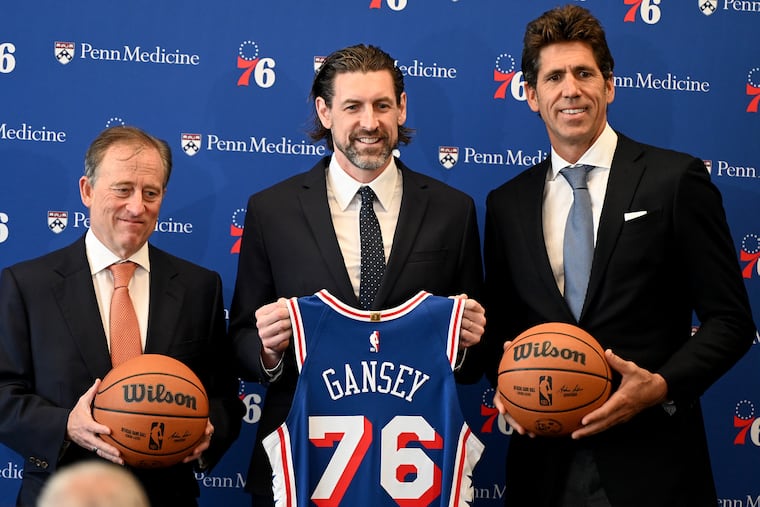 Mike Gansey (center) poses with Sixers managing partner Josh Harris (left) and president of sports for Harris Blitzer Sports & Entertainment Bob Myers (right) at Monday's introductory press conference.