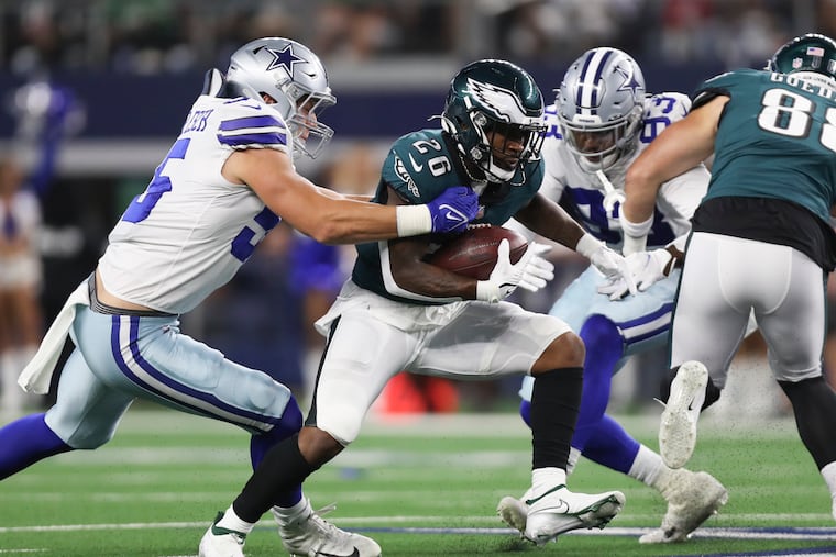 Miles Sanders runs past Dallas Cowboys outside linebacker Leighton Vander Esch in the second quarter Monday night.