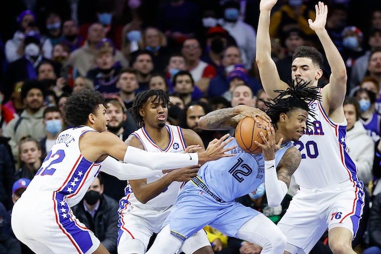 Memphis Grizzlies guard Ja Morant gets triple-teamed by Sixers guards Matisse Thybulle and Tyrese Maxey and forward Georges Niang.
