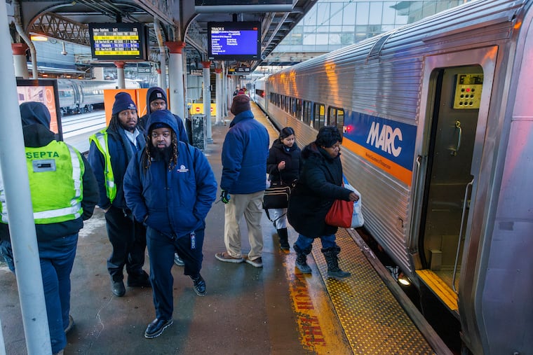 Commuters stepping onto leased MARC commuter rail cars on SEPTA's Trenton Regional Rail line at the Trenton Transit Center.