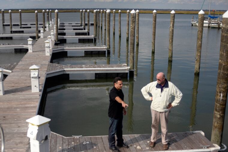 Two years after Hurricane Sandy, Sal Calabrese (left) is on his brand new North Dock with Larry Dubs (right) East Coast representative for Sullivan Flotation Systems (manufacturer of the floating dock system) at his family's Blue Water Marina in Margate, N.J., Oct. 21, 2014. (TOM GRALISH/Staff Photographer)
