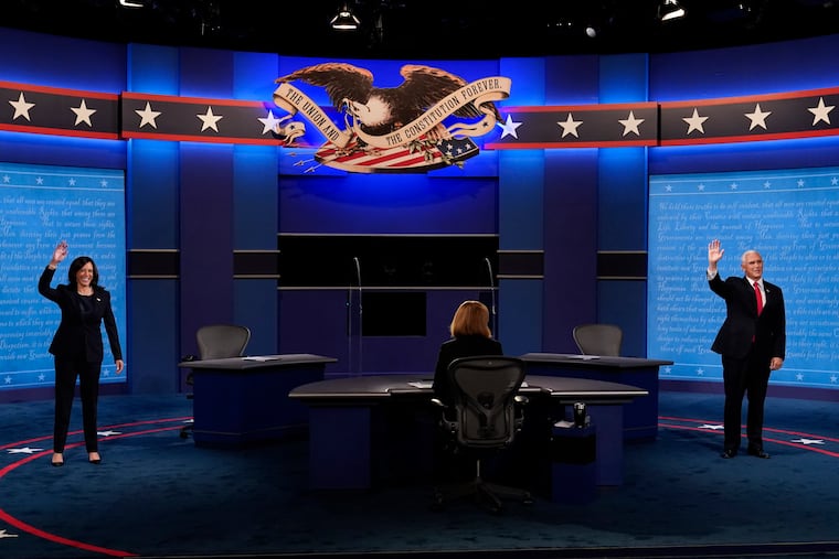 Democratic vice presidential candidate and then-Sen. Kamala Harris and then-Vice President Mike Pence wave before the vice presidential debate in 2020 at Kingsbury Hall on the campus of the University of Utah in Salt Lake City.
