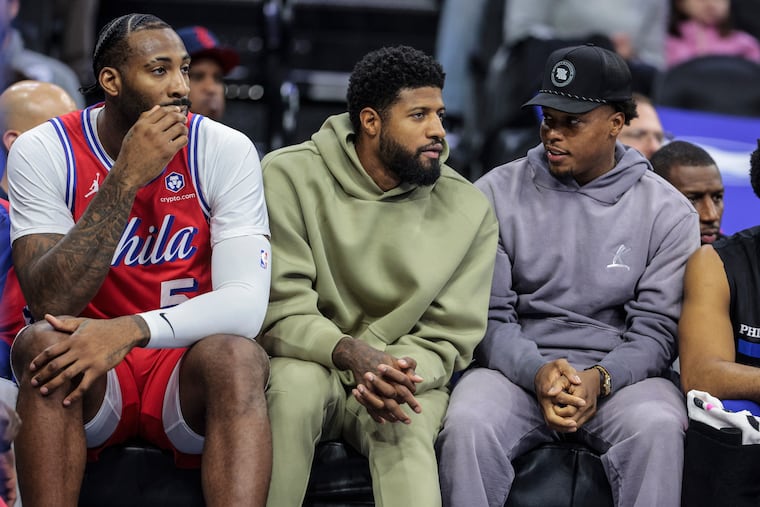 Andre Drummond (left) and the injured Paul George and Kyle Lowry watch the Sixers play the Nets on Friday. George is out with a knee injury for the second time this season.