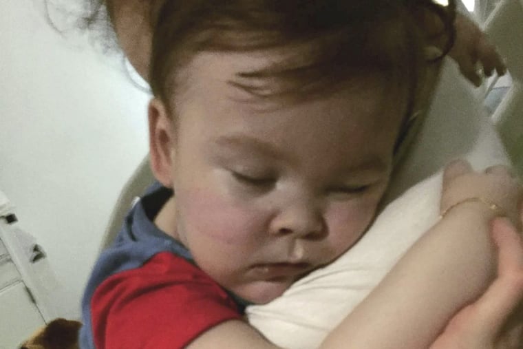 Brain-damaged toddler Alfie Evans cuddles his mother Kate James at Alder Hey Hospital, Liverpool, England. The father of a terminally ill British toddler said the child is surviving after being taken off life support, surprising doctors who had argued he should be allowed to die.