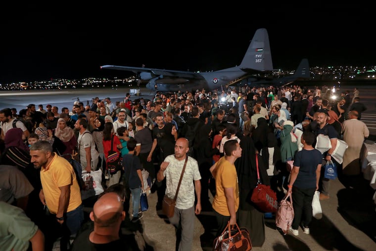 Jordanians evacuated from Sudan arrive at a military airport in Amman, Jordan, on Monday.