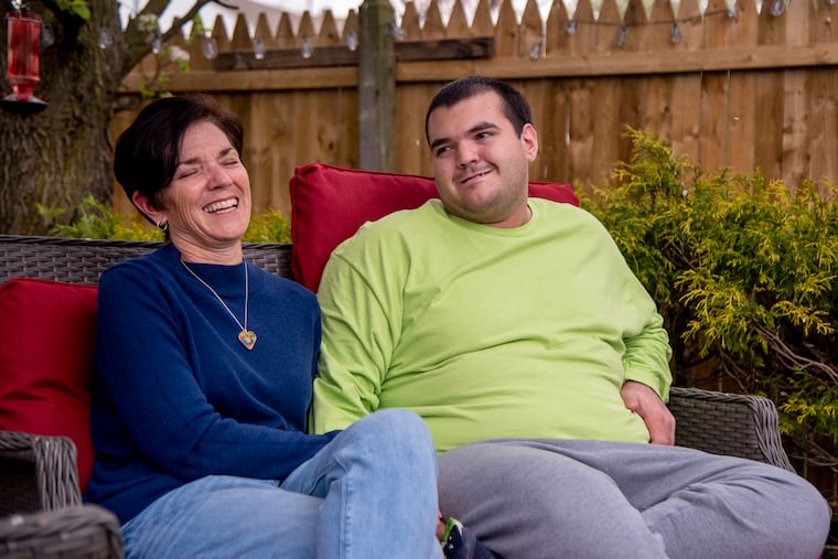 Laura Colnes and her son, Sammy, at their Marlton home Apr. 14, 2021. She is on a mission to convince the New Jersey legislature to pass a bill that would help protect students with disabilities from losing out on special education services because of the coronavirus crisis. Sammy missed his senior year in high school and lost time in a program that teaches life skills.