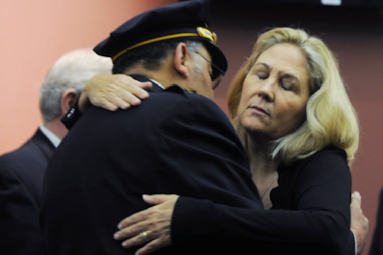 Maureen Faulkner, widow of slain Police Officer Daniel Faulkner, is hugged by Police Commissioner Charles H. Ramsey after the district attorney’s news conference, at which she spoke angrily. (Sarah J. Glover / Staff Photographer)