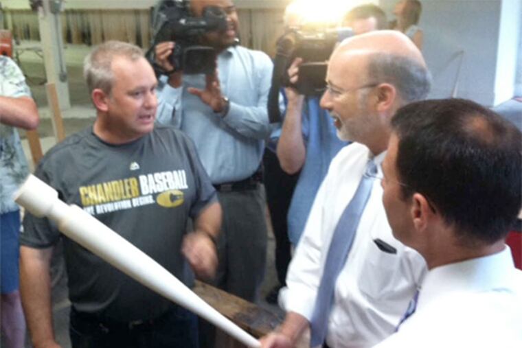 David Chandler (left), owner of Chandler Bats, gives Tom Wolf (center) a tour.