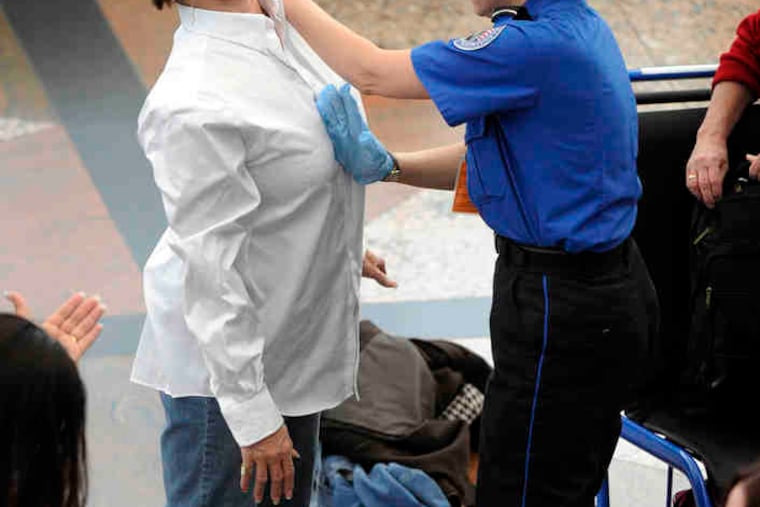 Two travelers undergo searches at Denver International Airport.The pat-downsof breasts and groin areas have drawn objections.